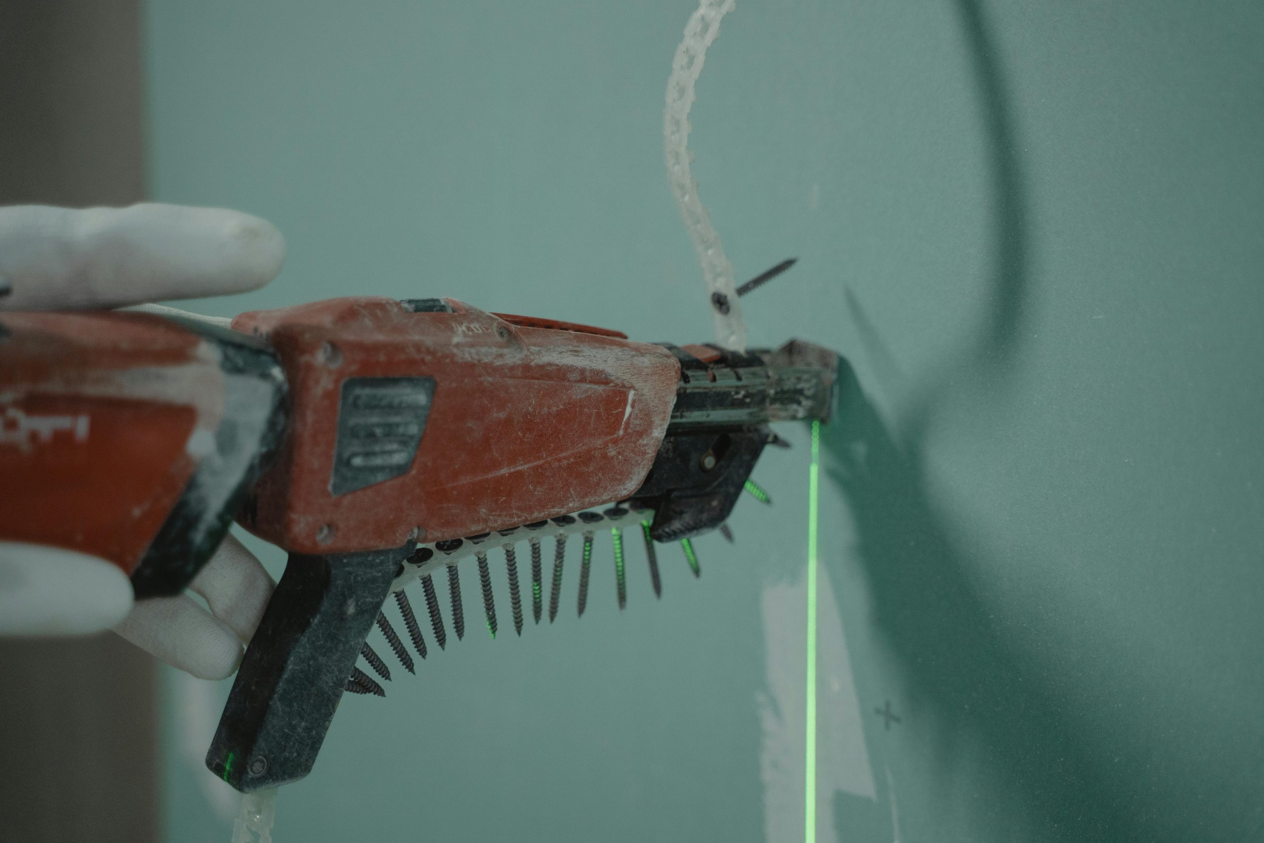 A close-up of a person using a power drill for home improvement or construction work.